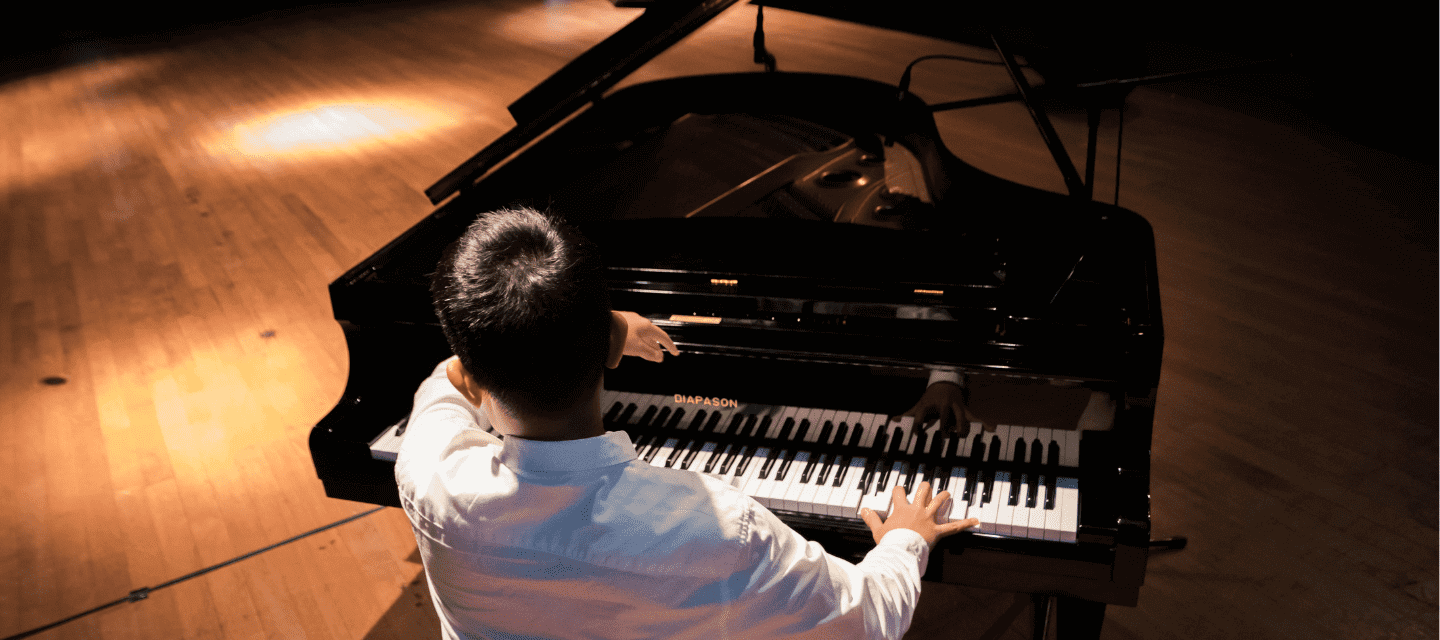 Man playing piano - Artisan Piano Tuning and Restoration